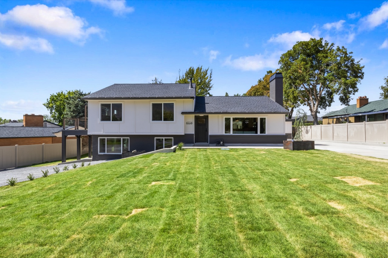 4554 S Willow Rd — white board-and-batten exterior on a wide lawn.